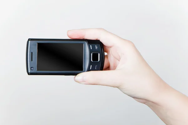 Teléfono móvil en su mano — Foto de Stock