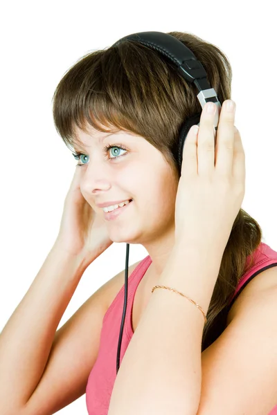 Beautiful girl in headphones listens to music — Stock Photo, Image