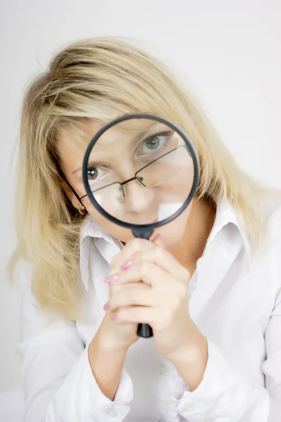 stock image Girl with a magnifying glass on a light background