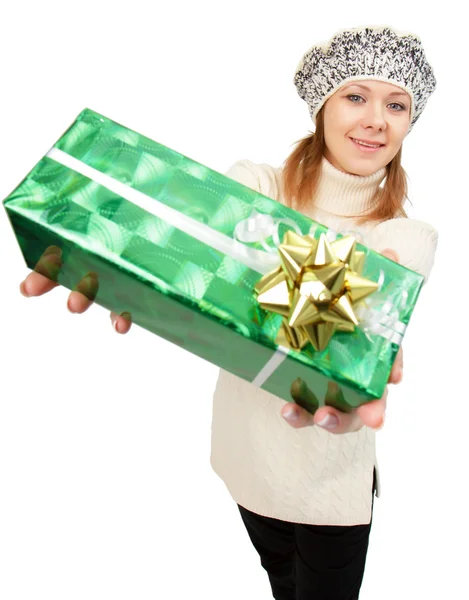 Girl in winter hat gives gift box — Stock Photo, Image