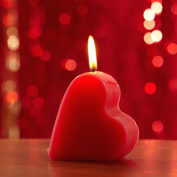 Red burning heart shaped candle — Stock Photo, Image