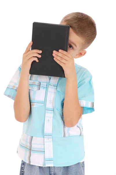 O menino segura o livro preto — Fotografia de Stock