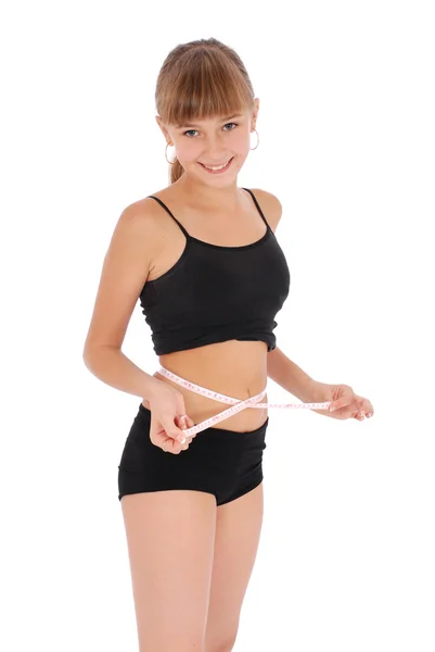 Niña sobre fondo blanco midiendo cintura con cinta métrica —  Fotos de Stock
