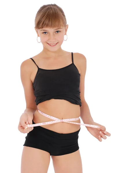 Girl on white background measuring waist with tape measure — Stock Photo, Image