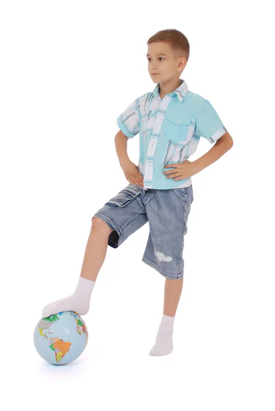 Boy has put a foot on the globe — Stock Photo, Image