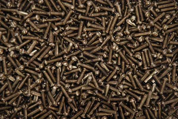 Background from the big number of screws — Stock Photo, Image
