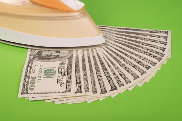 Dollars lay under an electric iron — Stock Photo, Image