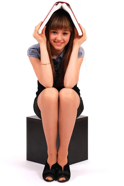 Girl holds the book on a head — Stock Photo, Image