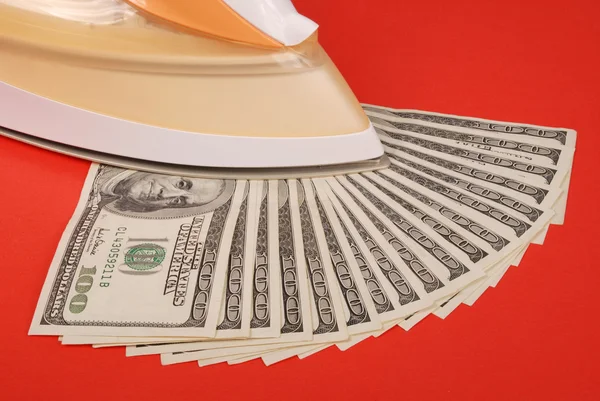 Dollars lay under an electric iron — Stock Photo, Image
