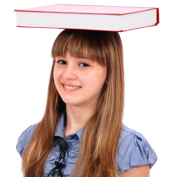 Menina segura o livro em uma cabeça — Fotografia de Stock