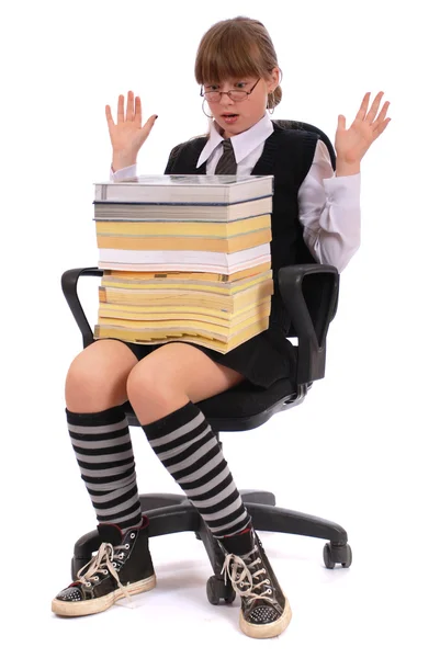 Girl has put the big pile of books on knees — Stock Photo, Image