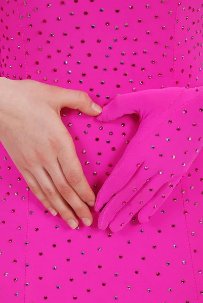 Hands on a pink fabric