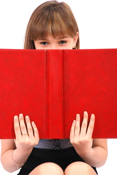 Dívka má skryté za otevřená kniha — Stock fotografie