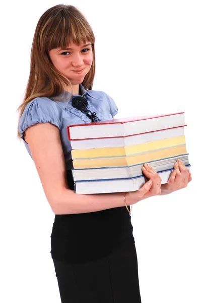 La chica sostiene la gran pila de libros. Ha inflado las mejillas —  Fotos de Stock