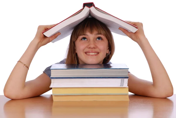 Menina segura o livro vermelho em uma cabeça — Fotografia de Stock