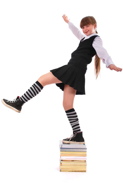 Dívka skáče z hromady knih — Stock fotografie