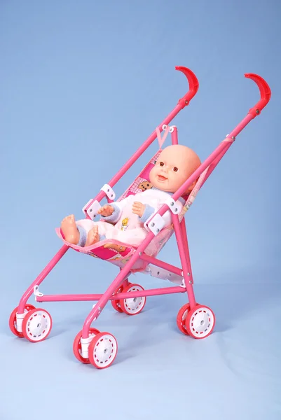 Toy baby buggy on blue background — Stock Photo, Image