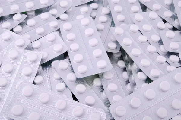 Bakgrund från den stora högen av vita tabletter — Stockfoto