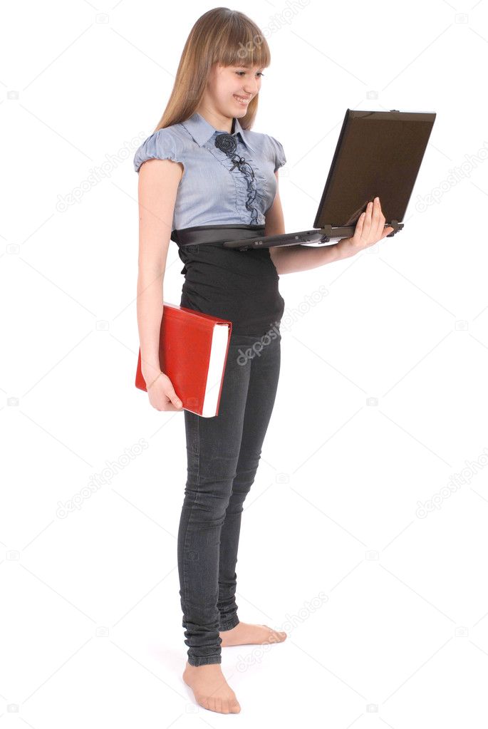 Girl holds the red book and looks in laptop. On white background