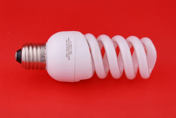 Compact Fluorescent Light Bulb Red Backlground — Stock Photo, Image