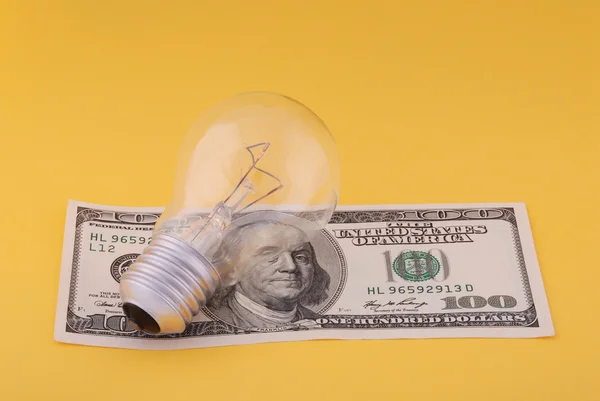 Electric lamp on hundred dollars — Stock Photo, Image