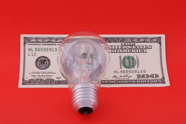 Electric lamp on hundred dollars — Stock Photo, Image