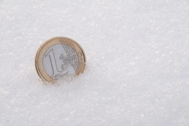 The lost coins on a snow. One Euro clipart