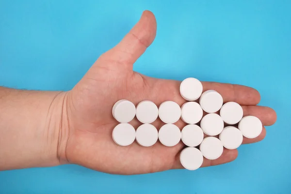 Pilen Kombineras Från Vita Tabletter Pilen Lägger Hand Blå Bakgrund — Stockfoto