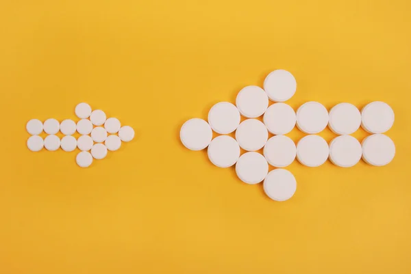 Two Arrows Collected Tablets Directed Each Other Yellow Background — Stock Photo, Image