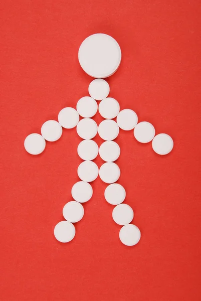 Little man combined from white tablets. — Stock Photo, Image