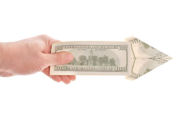 Arrow in a hand made of dollars isolated on white