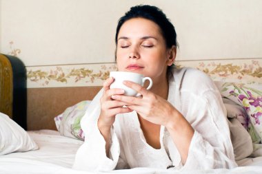 A young woman dreaming on bed clipart