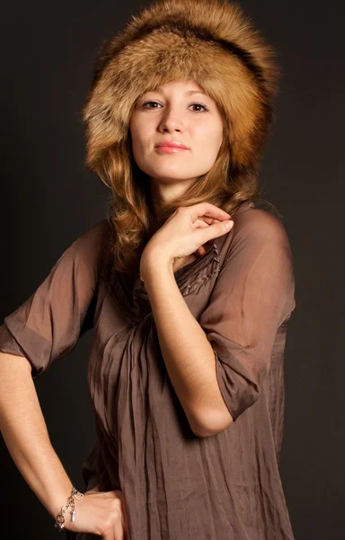 Woman in a fur hat looking aside — Stock Photo, Image