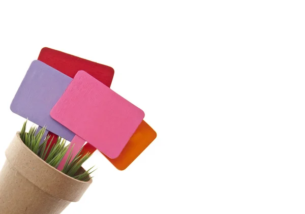 Hrnec trávy s několika prázdné barevných značek — Stock fotografie