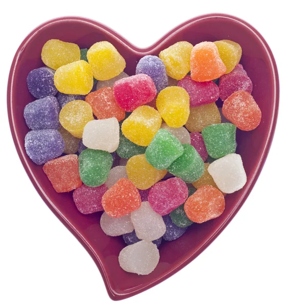 Słodycze przyprawy spada w czerwone serce w kształcie misy — Zdjęcie stockowe