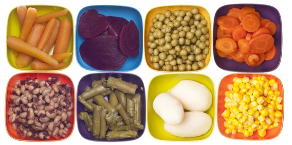 Variété de légumes en conserve dans des bols colorés — Photo