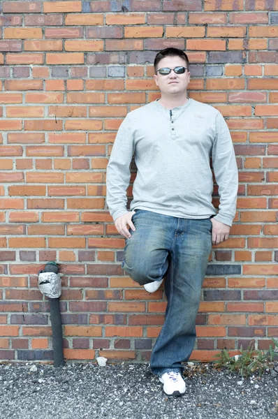 stock image Brown Haired Caucasian Man on a Brick Wall