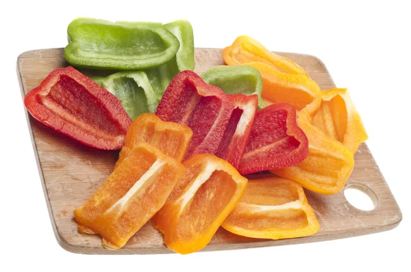Szeletelt narancs, zöld és piros paprika — Stock Fotó