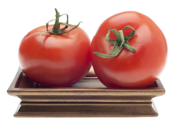 Par de tomates em um prato dourado — Fotografia de Stock