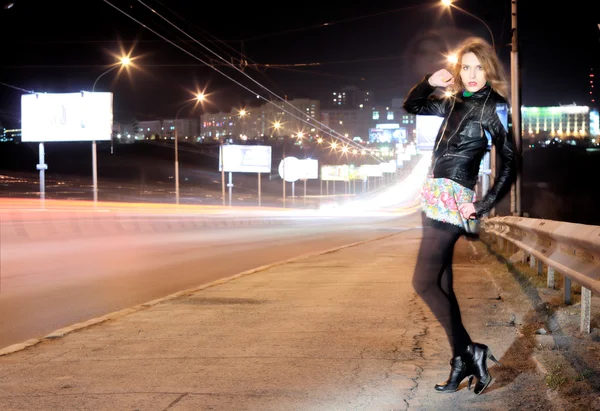 Nattporträtt av flicka nära motorväg — Stockfoto