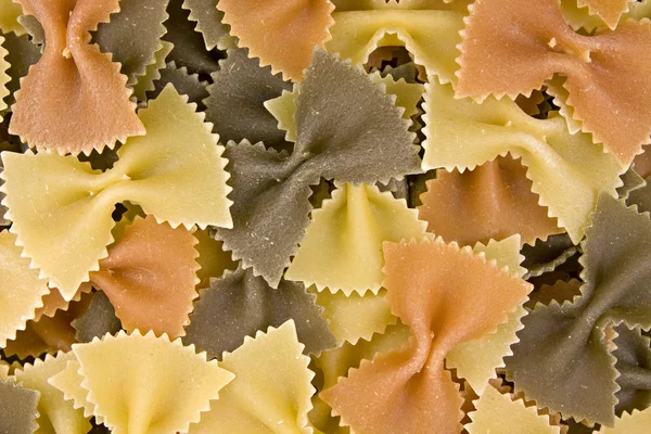 stock image Close up of uncooked multi-colored bow pasta