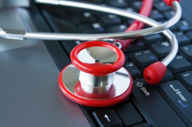 Stethoscope on a computer keyboard clipart