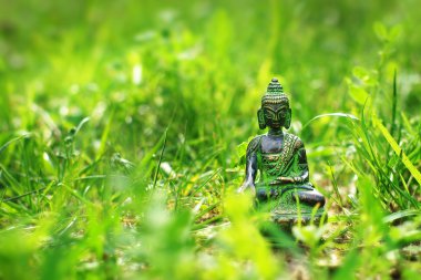 Buddha statue in the grass clipart