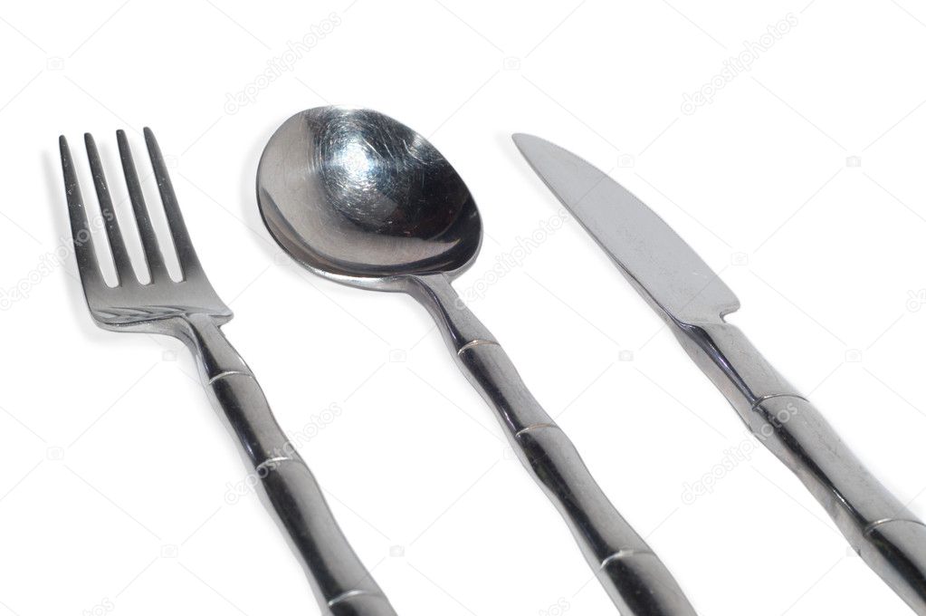 Plug, the spoon and a knife from nickel, isolated on white