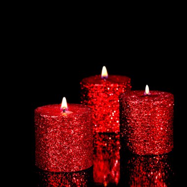 Three spangled candles in the dark clipart