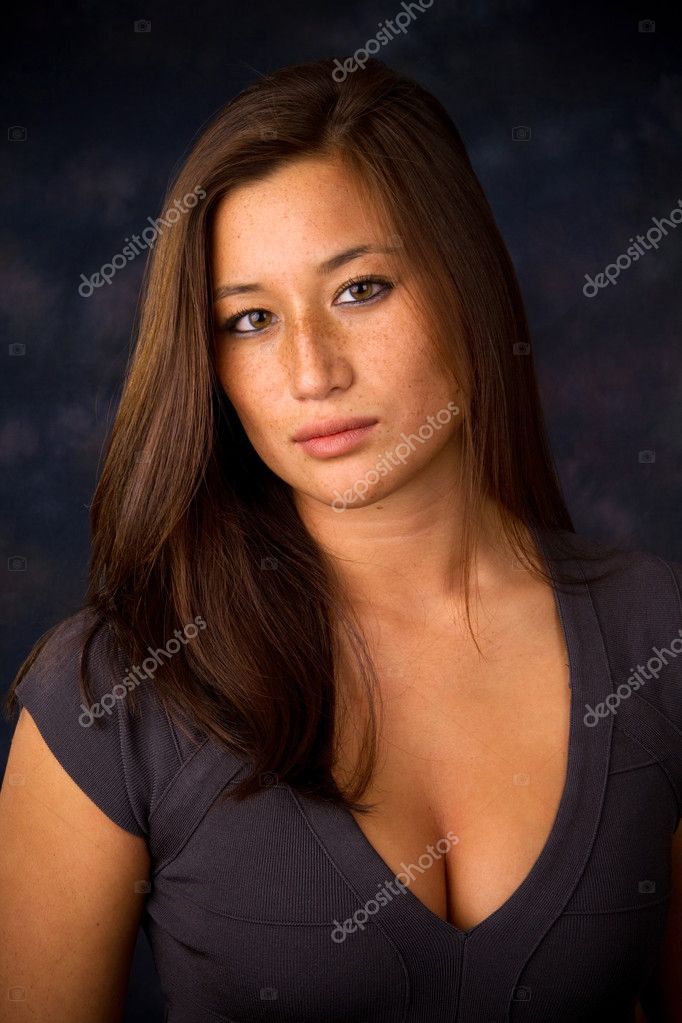 Young Sexy Woman Wearing A Low Cut Dress Shows Off Her Cleavage