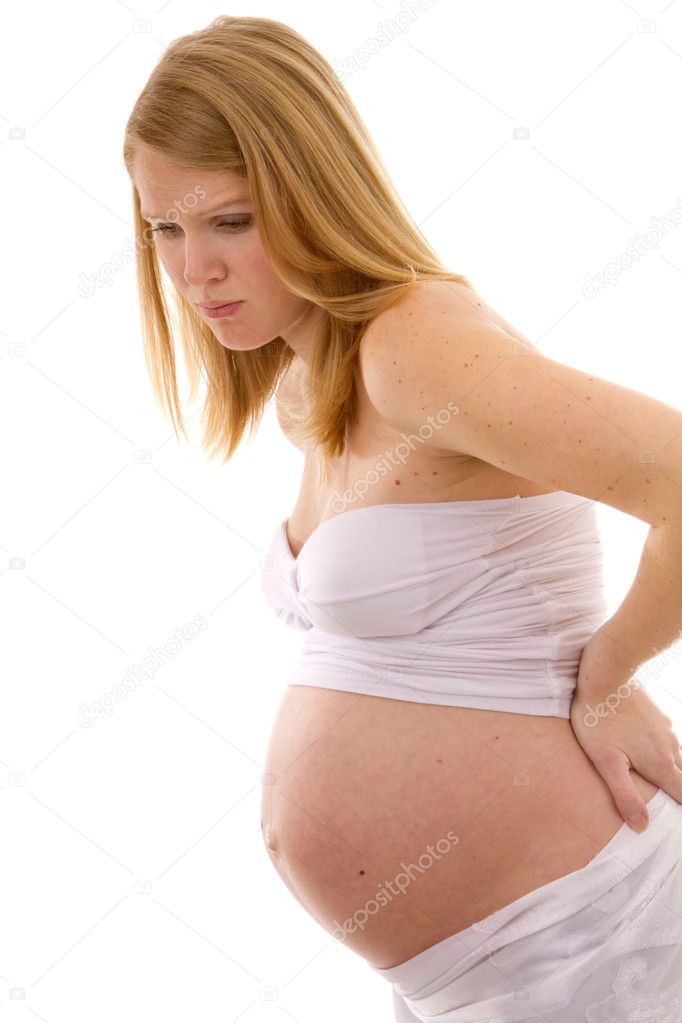 Pregnant woman bends over holding her back in pain.