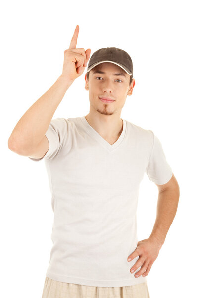 Casual young man in a hat is pointing up. Isolated on white.
