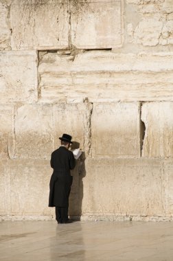 Prayers and tourists near Jerusalem wall clipart