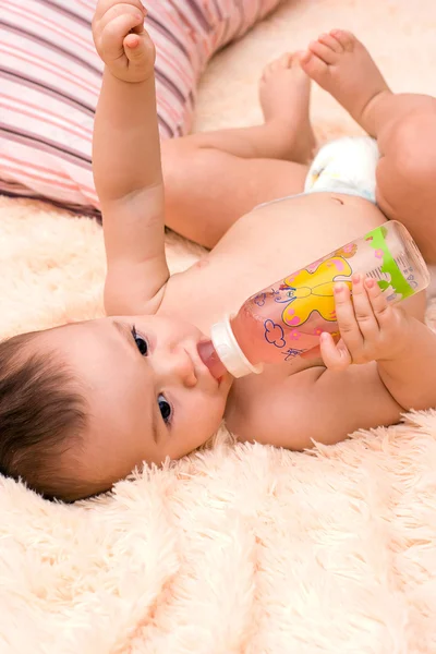 Little caucasian boy drinking from the bottle — Stock Photo, Image